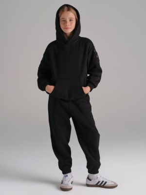 Travel Essentials Kids Sweatpants: Raphaella is 10, 56" tall wearing size S