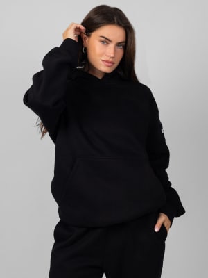 Travel Essentials Hoodie™: Lauren is 5’8” and wears a size M